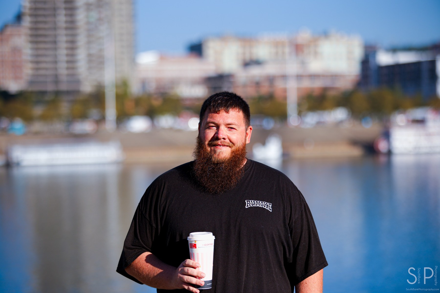 Environmental portrait beside the Ohio River with Cincinnati in the background