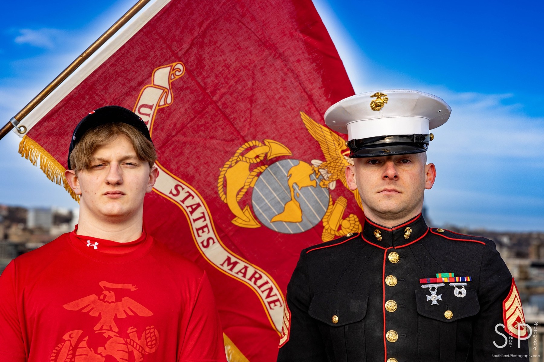 Portrait of a senior and a United States Marine with a Marine Corps flag