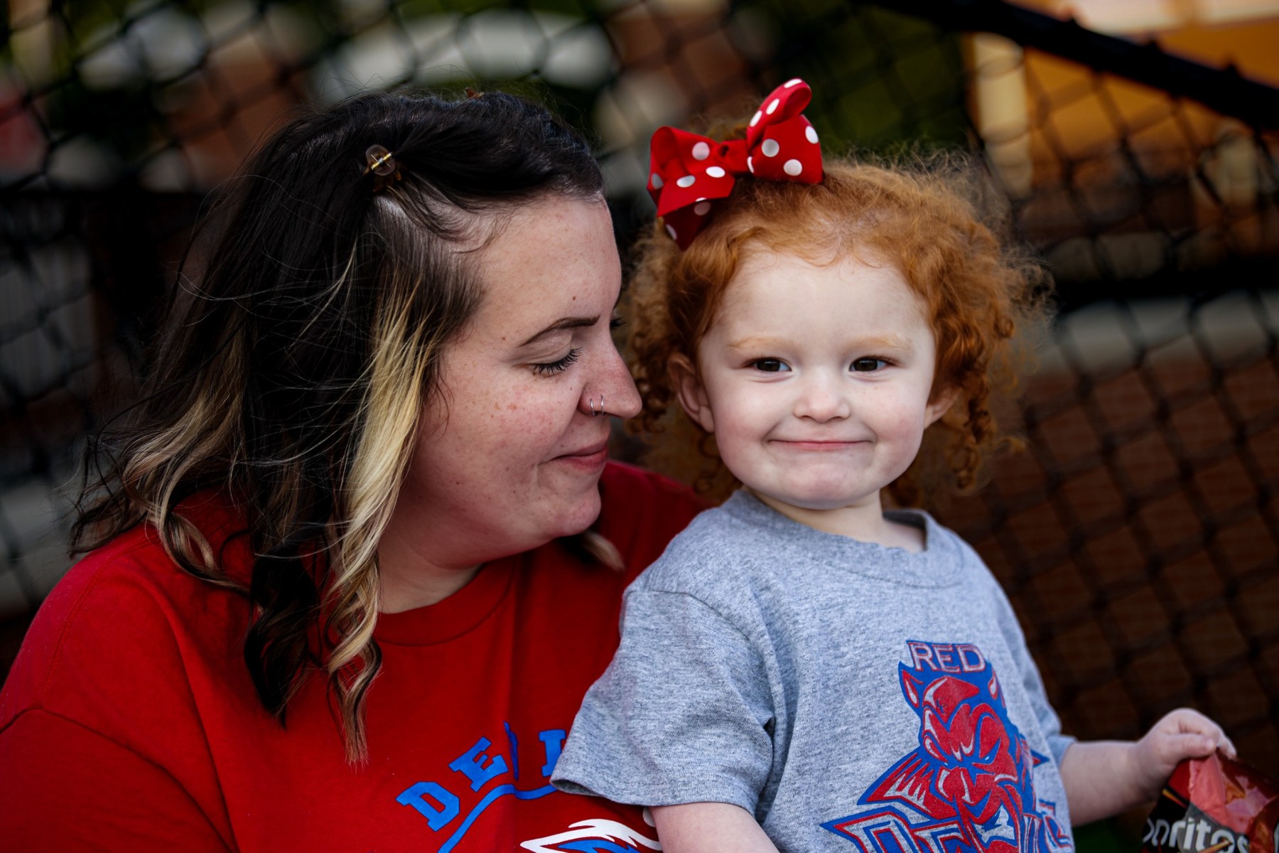 Mother and young daughter sharing a quiet moment at a community event