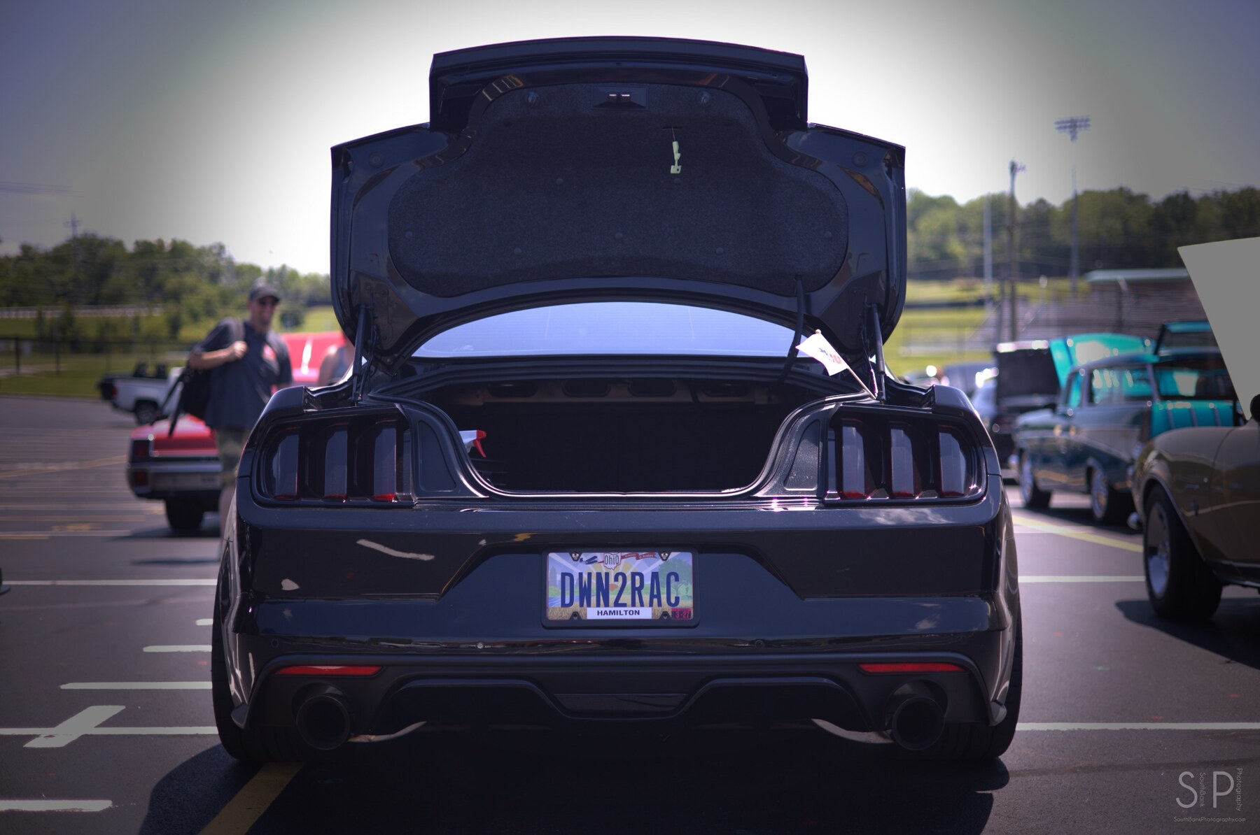 Rear view of a black Ford Mustang with its trunk open