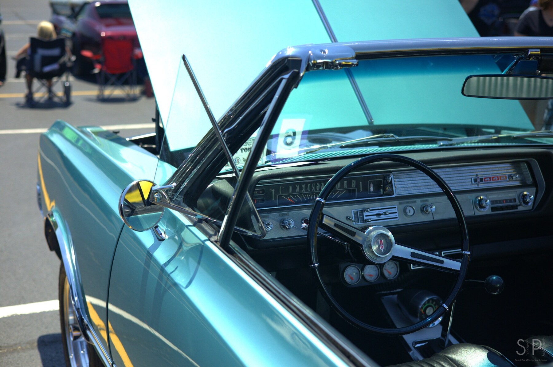 Turquoise 1965 Oldsmobile 442 convertible interior viewed over the driver door