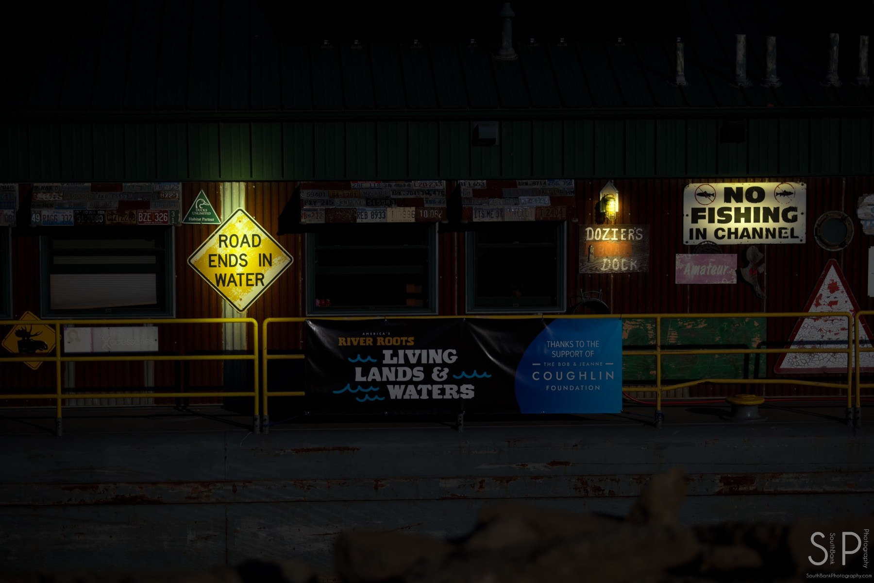 Riverfront dock signs illuminated at night