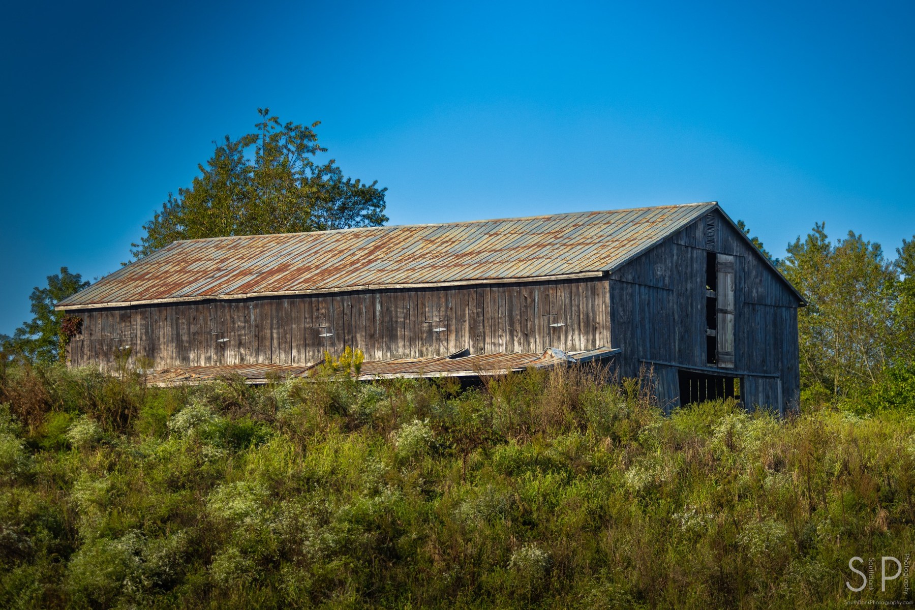 Weathered wooden barn on a rural Kentucky hillside